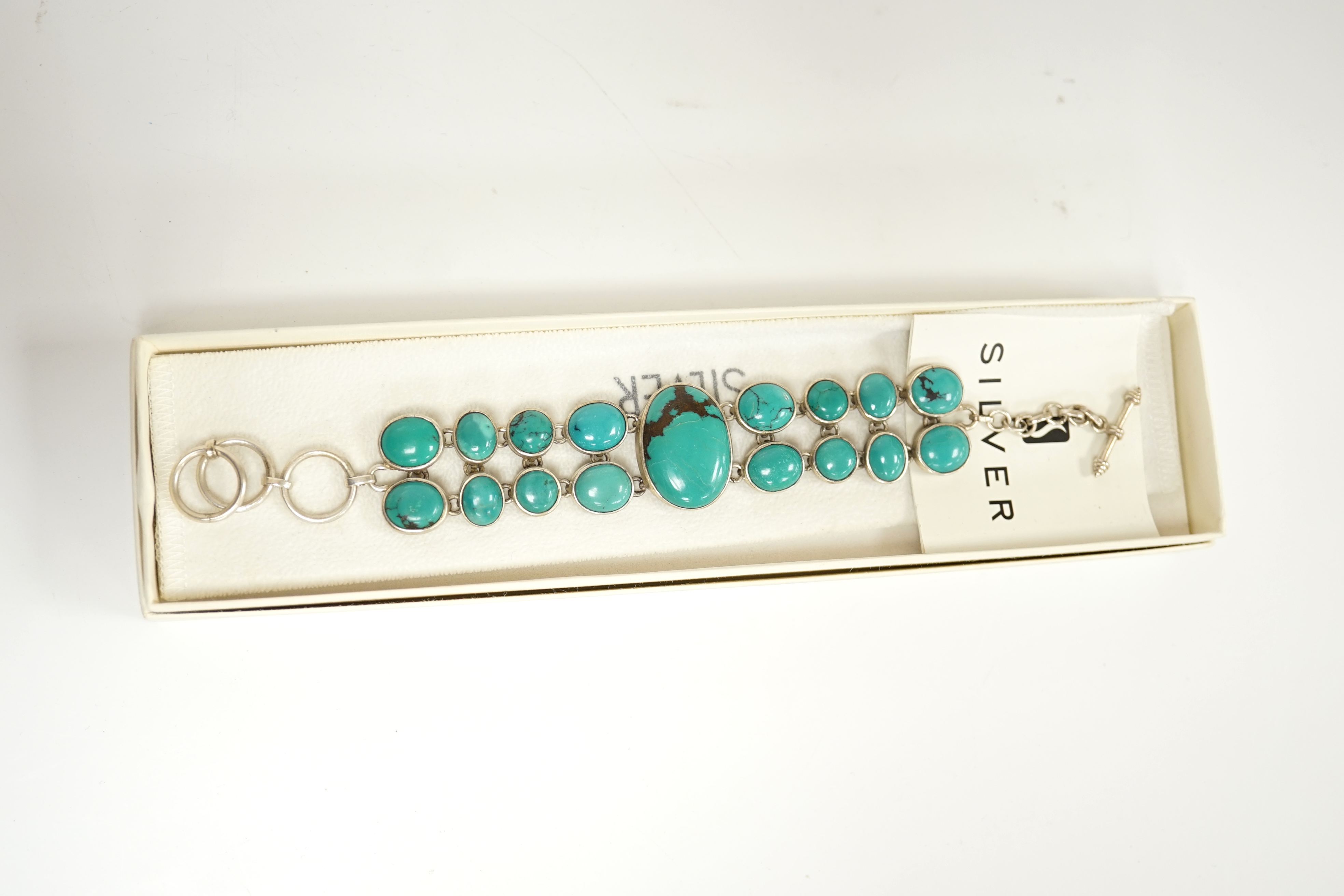 A modern silver and two row turquoise cluster set bracelet, overall 22cm. Condition - good